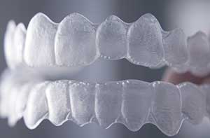 A clear invisalign and a blur grey background