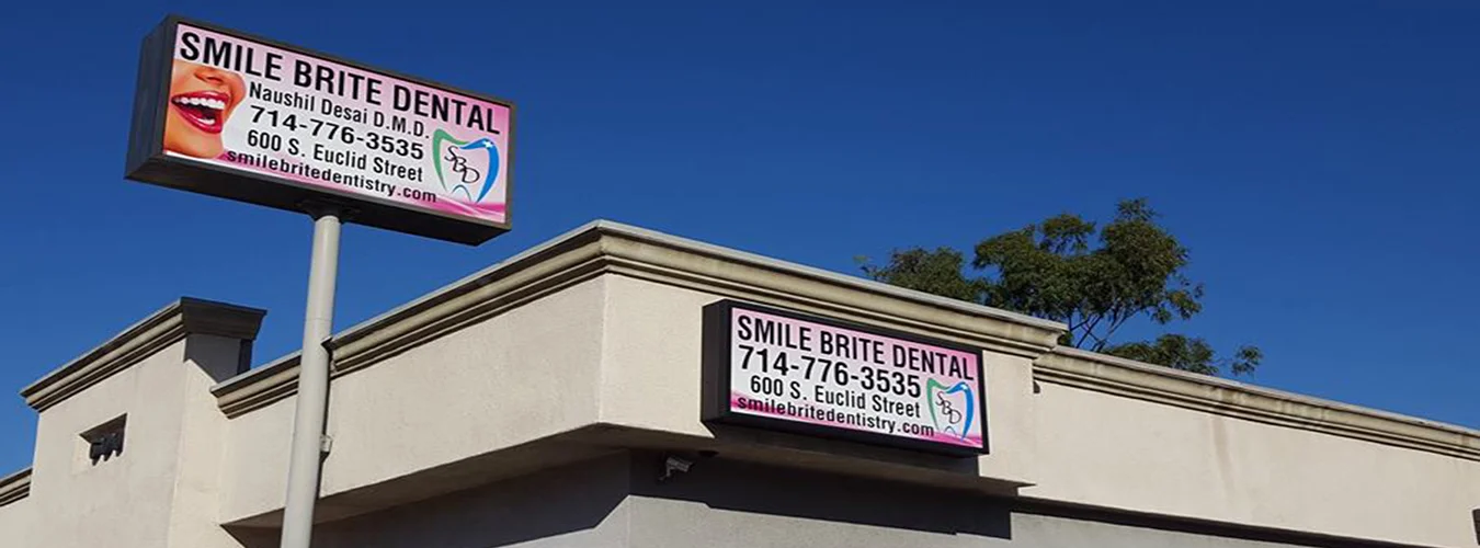 A dental clinic's signage, blue sky