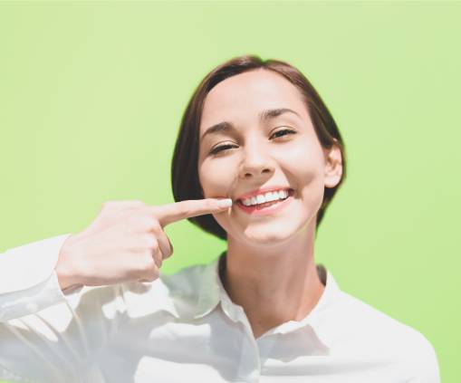 Woman smiling and pointing on her teeth