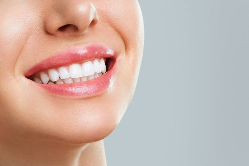 Perfect healthy teeth smile of a young woman. Teeth whitening. Dental clinic patient.